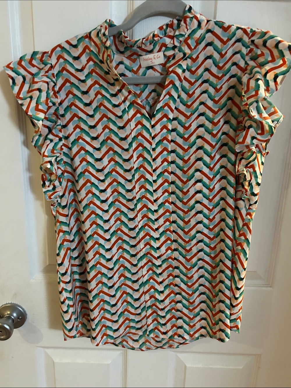 Hailey  & Co. Chevron Ruffle Sleeve Blouse in Ivory with Teal & Coral